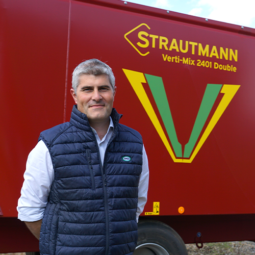 Dean Cottey, OPICO Territory Manager and Strautmann Product manager in the UK, stood in front of a Strautmann Verti-Mix 2401 Double Diet Feeder